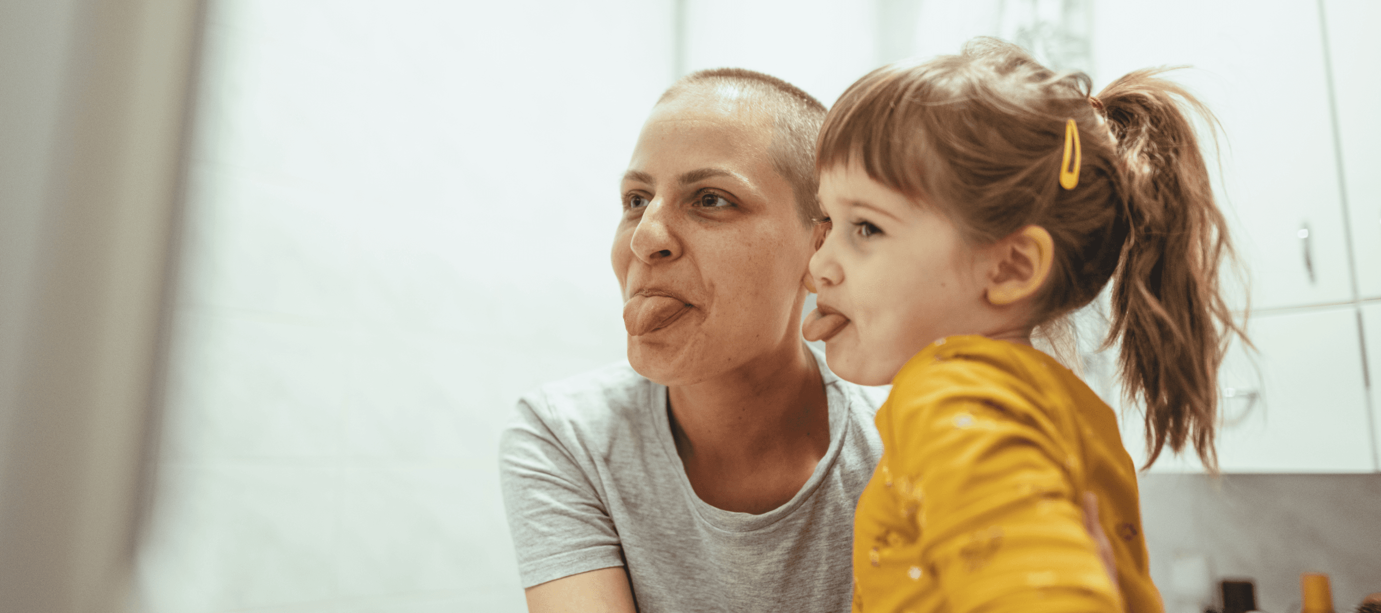 Mother and daughter making funny faces together