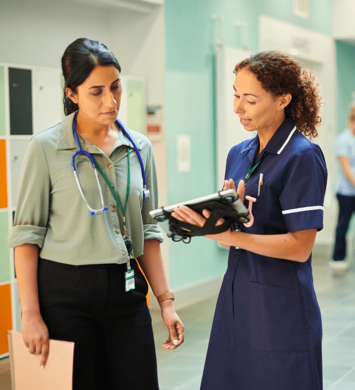 medical professionals talking about some information they are reading on a tablet